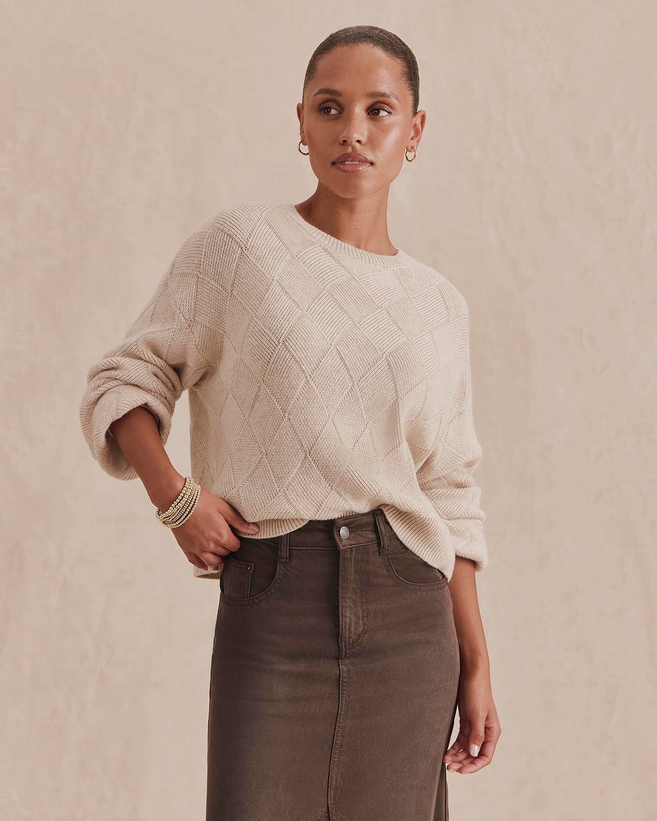 Model wearing Splendid Solstice cream diamond-knit sweater paired with brown denim midi skirt