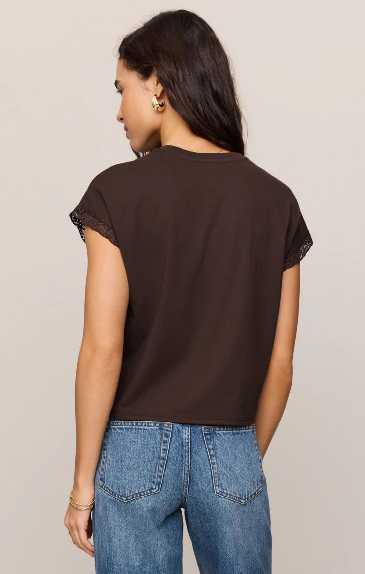 Dark brown muscle tee with lace trim sleeves, worn with blue jeans, back view