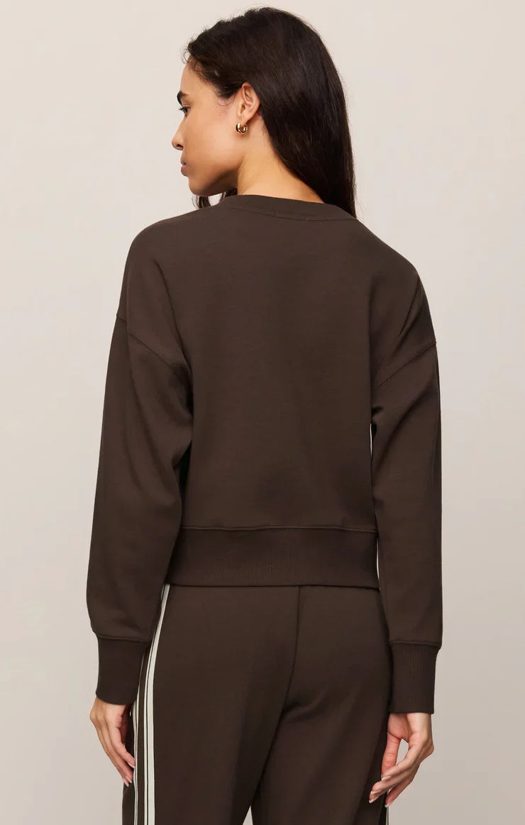 Back view of Z Supply Comeback Sweatshirt in Eclipse dark brown on female model