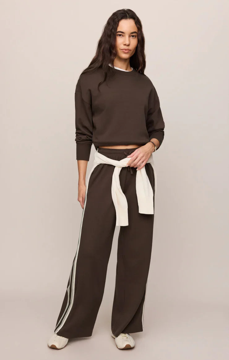 Model wearing Z Supply Comeback Sweatshirt in Eclipse dark brown cropped style with matching wide-leg pants