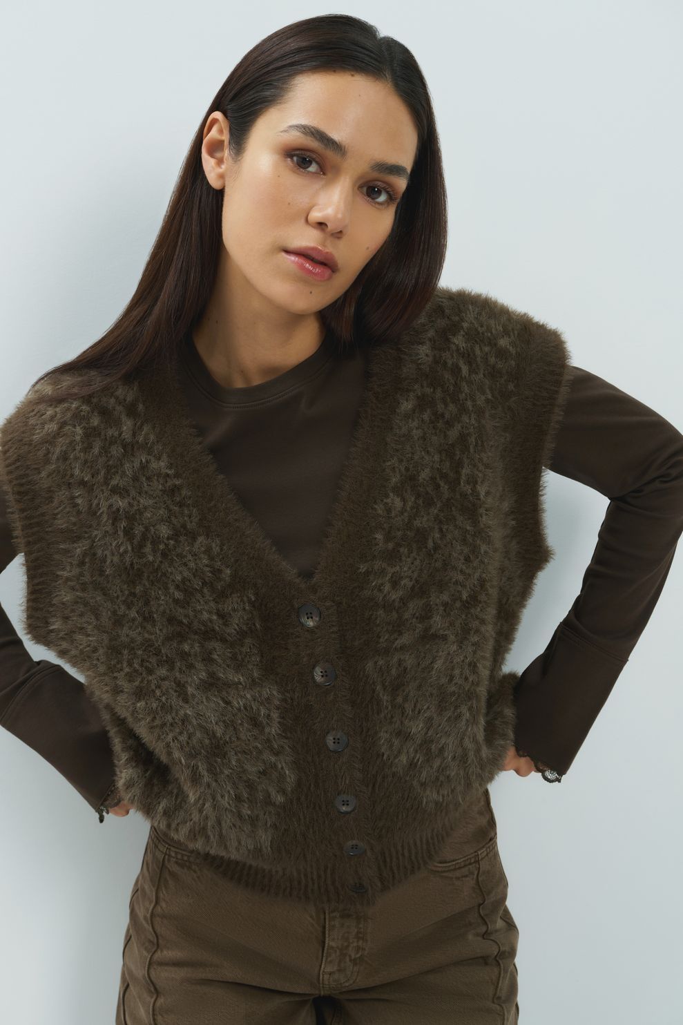 Olive brown fuzzy faux fur sleeveless button-front cardigan vest on model