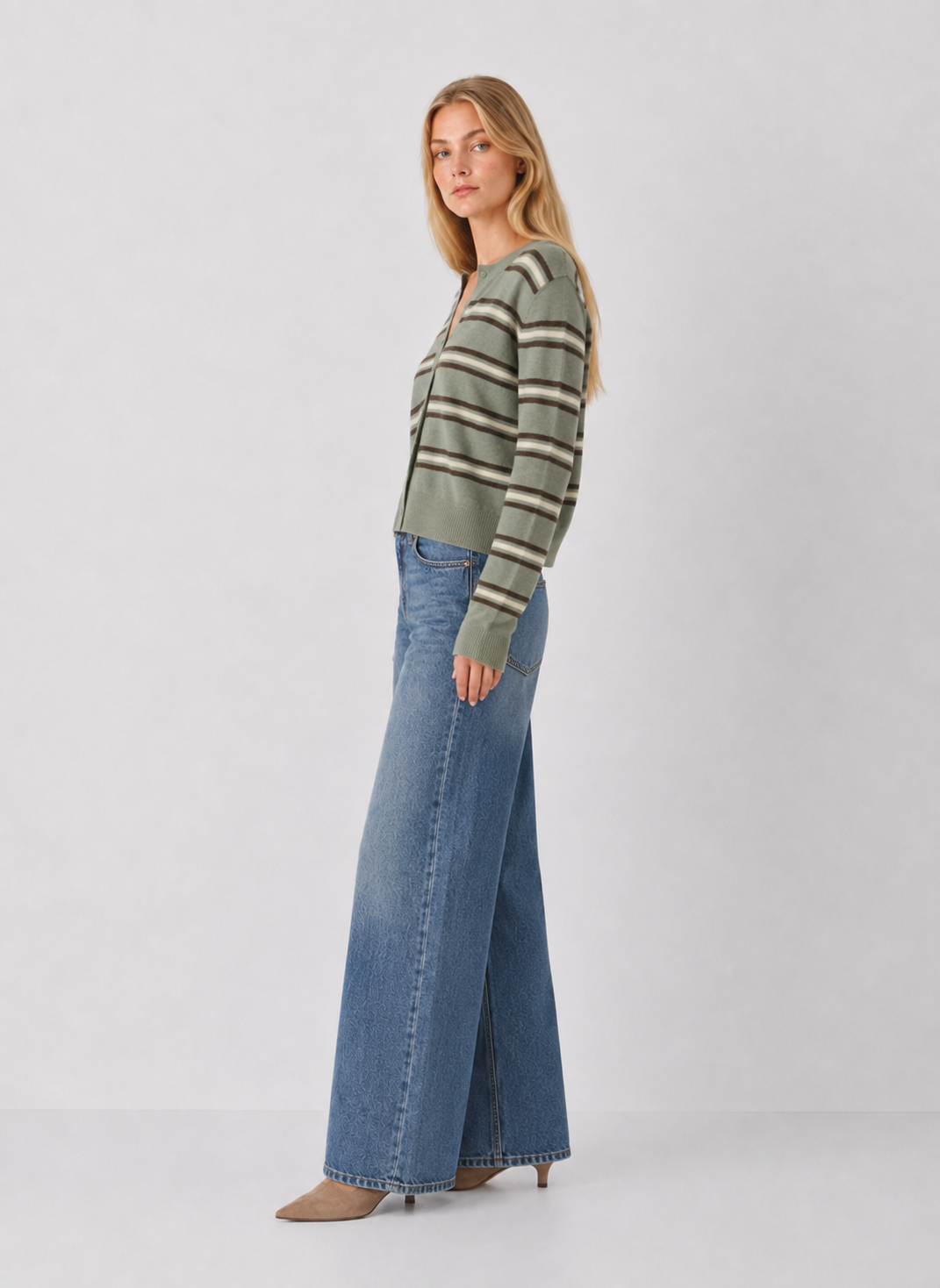 Model wearing Z Supply Medina Stripe Cardigan in Aqua Cloud with wide-leg jeans, side view