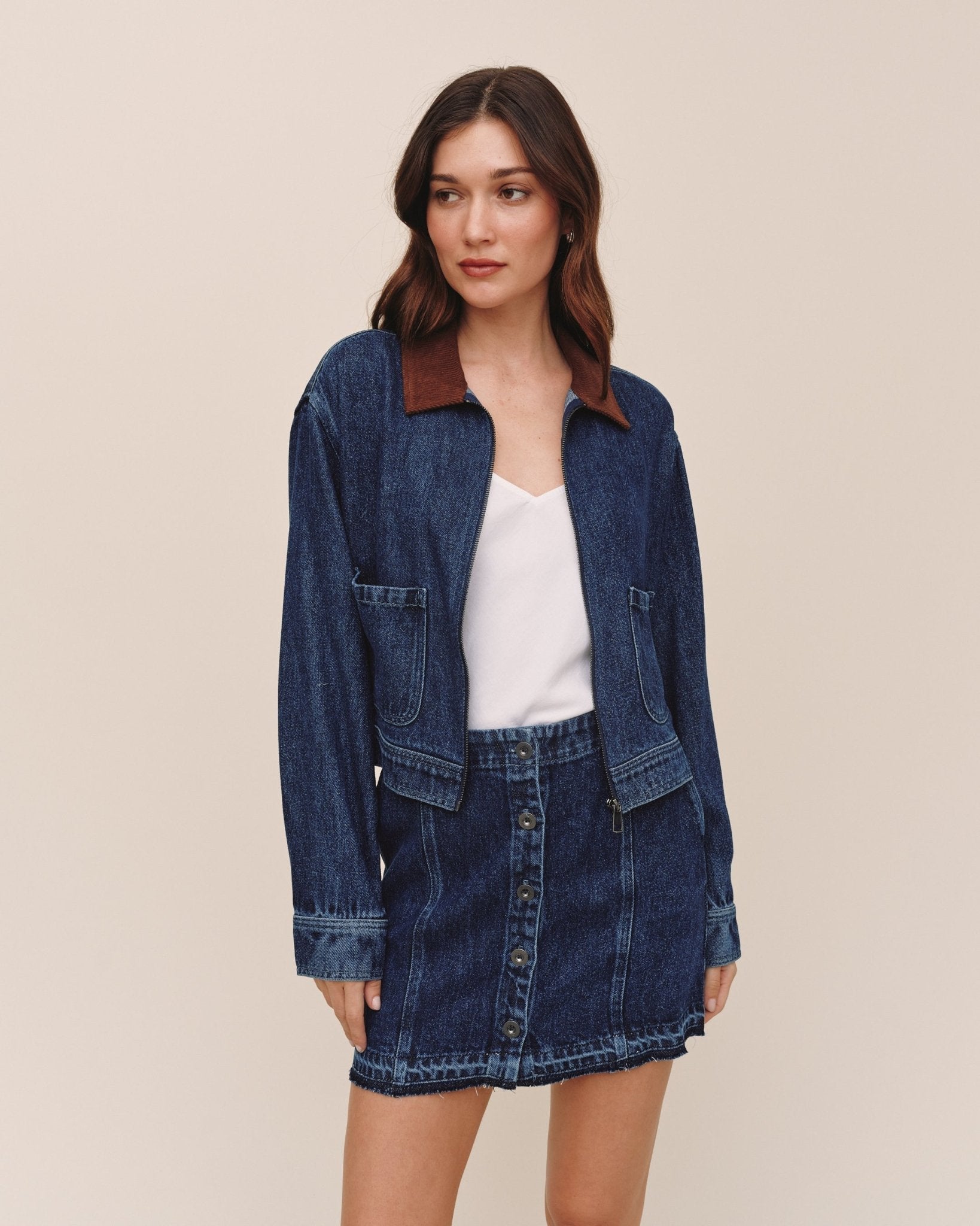 Model wearing Bella Dahl dark rinse wash denim crop zip-up barn jacket with matching mini skirt