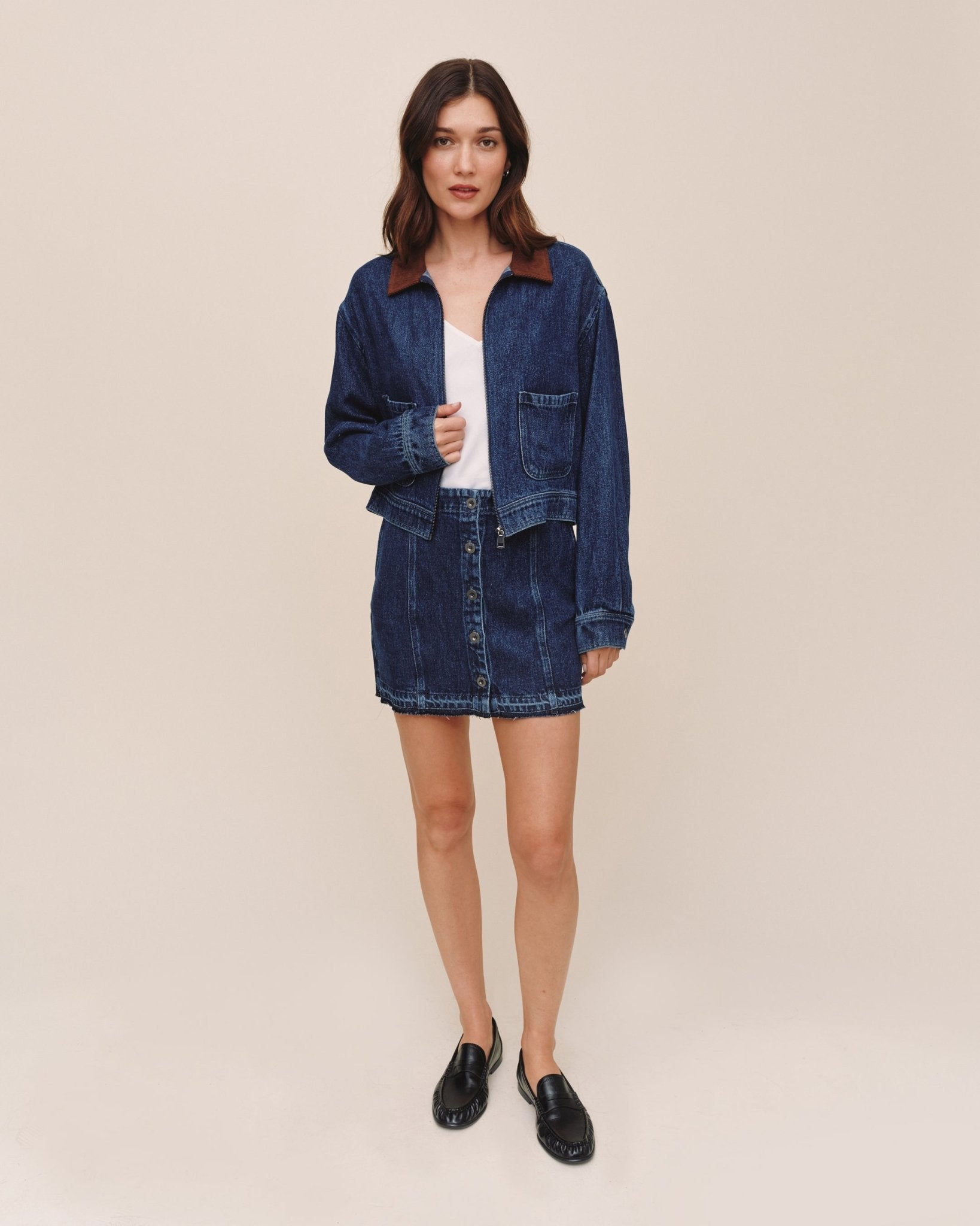Model wearing Bella Dahl dark rinse wash denim crop zip-up barn jacket with matching mini skirt