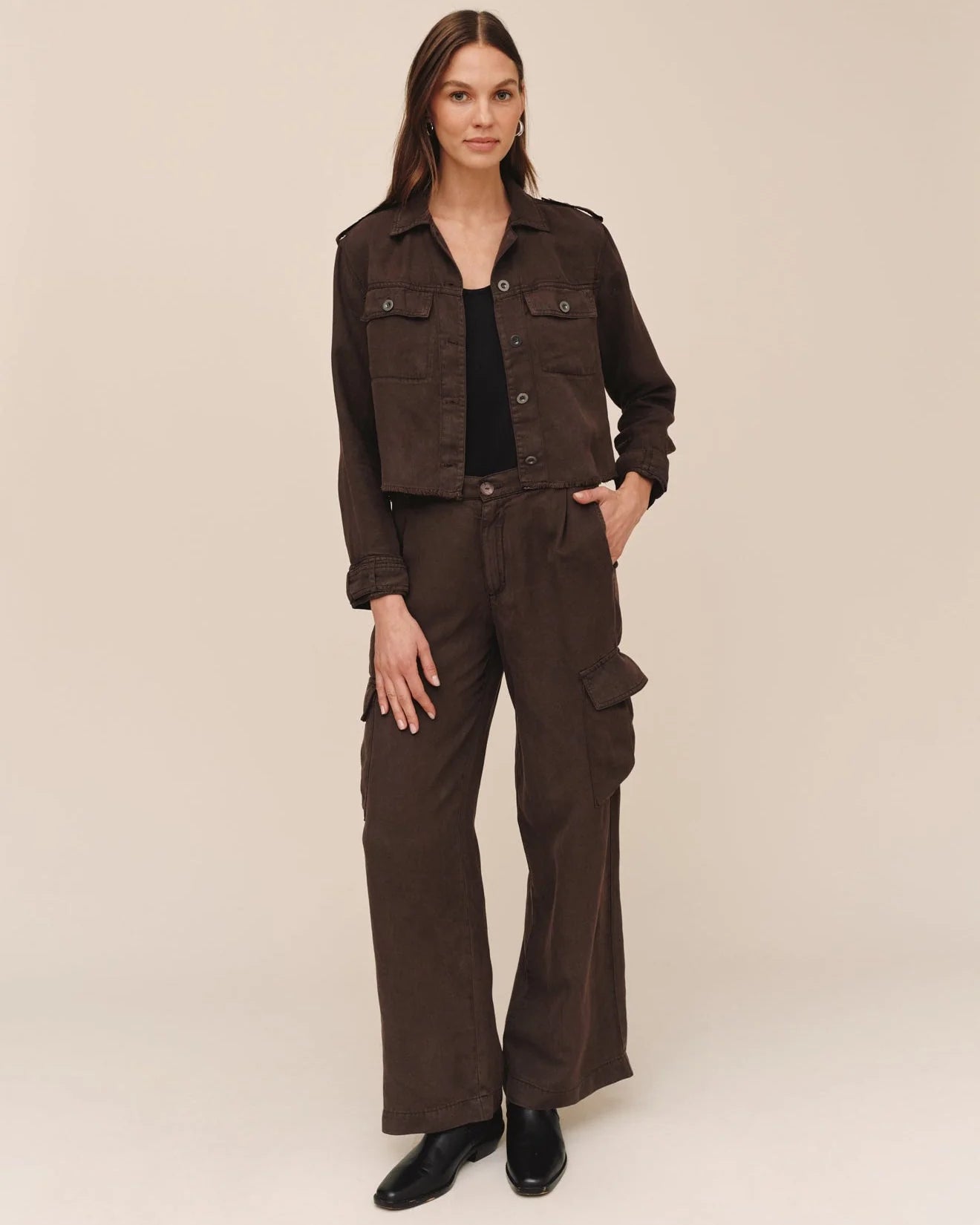 Dark brown cropped utility jacket with flap pockets and frayed hem, long sleeves