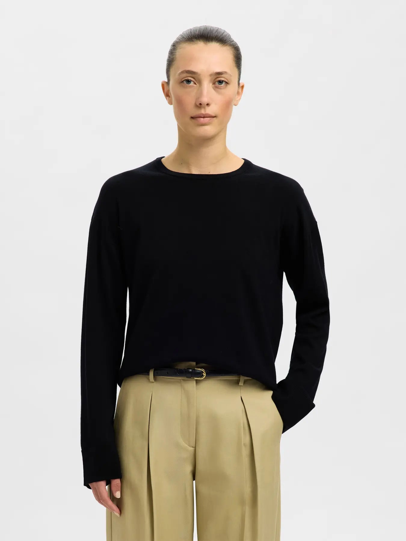 Black merino wool long-sleeve crew neck knit sweater on female model