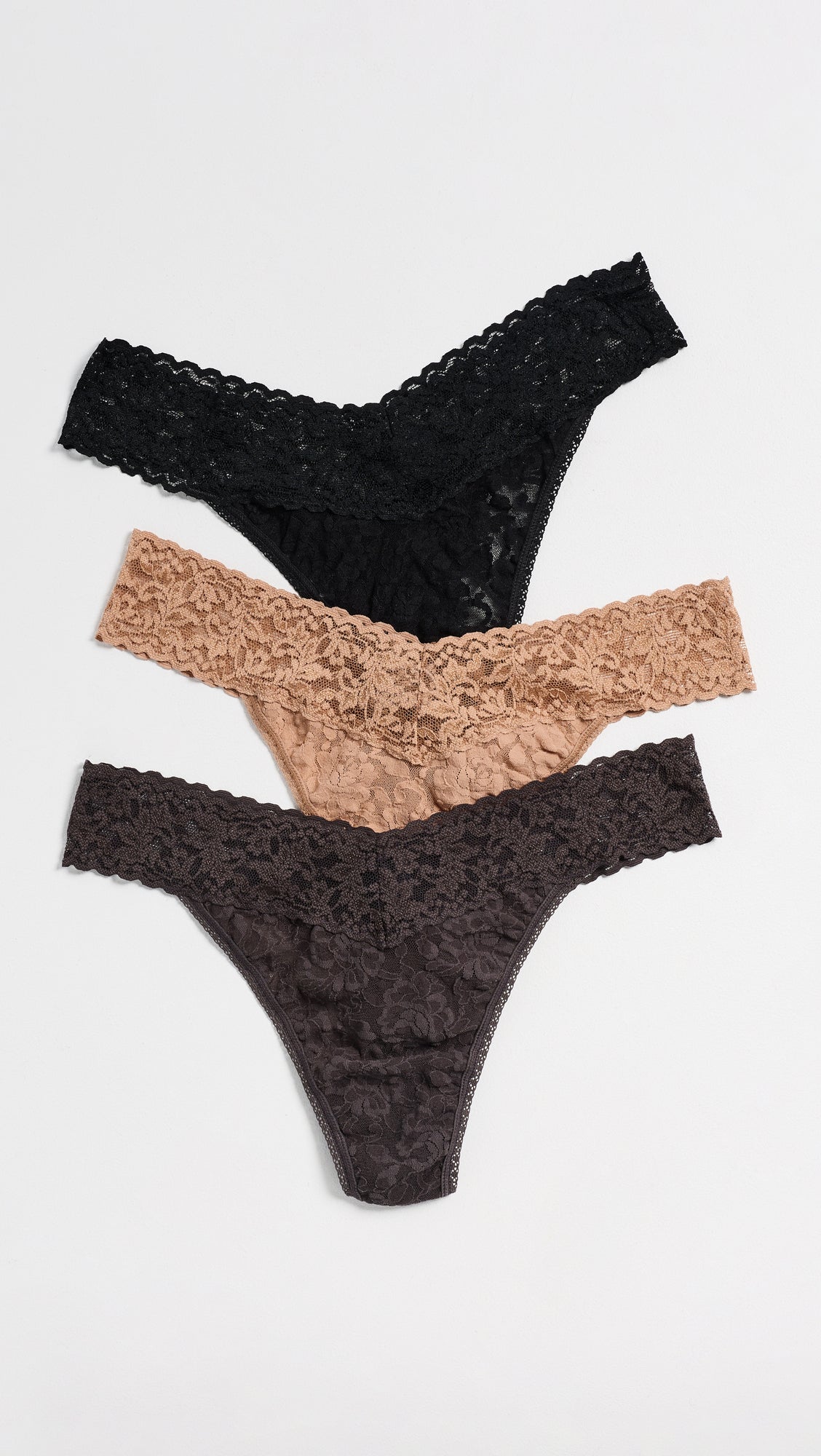 Hanky Panky three-pack lace thongs in black, nude, and dark brown flat lay
