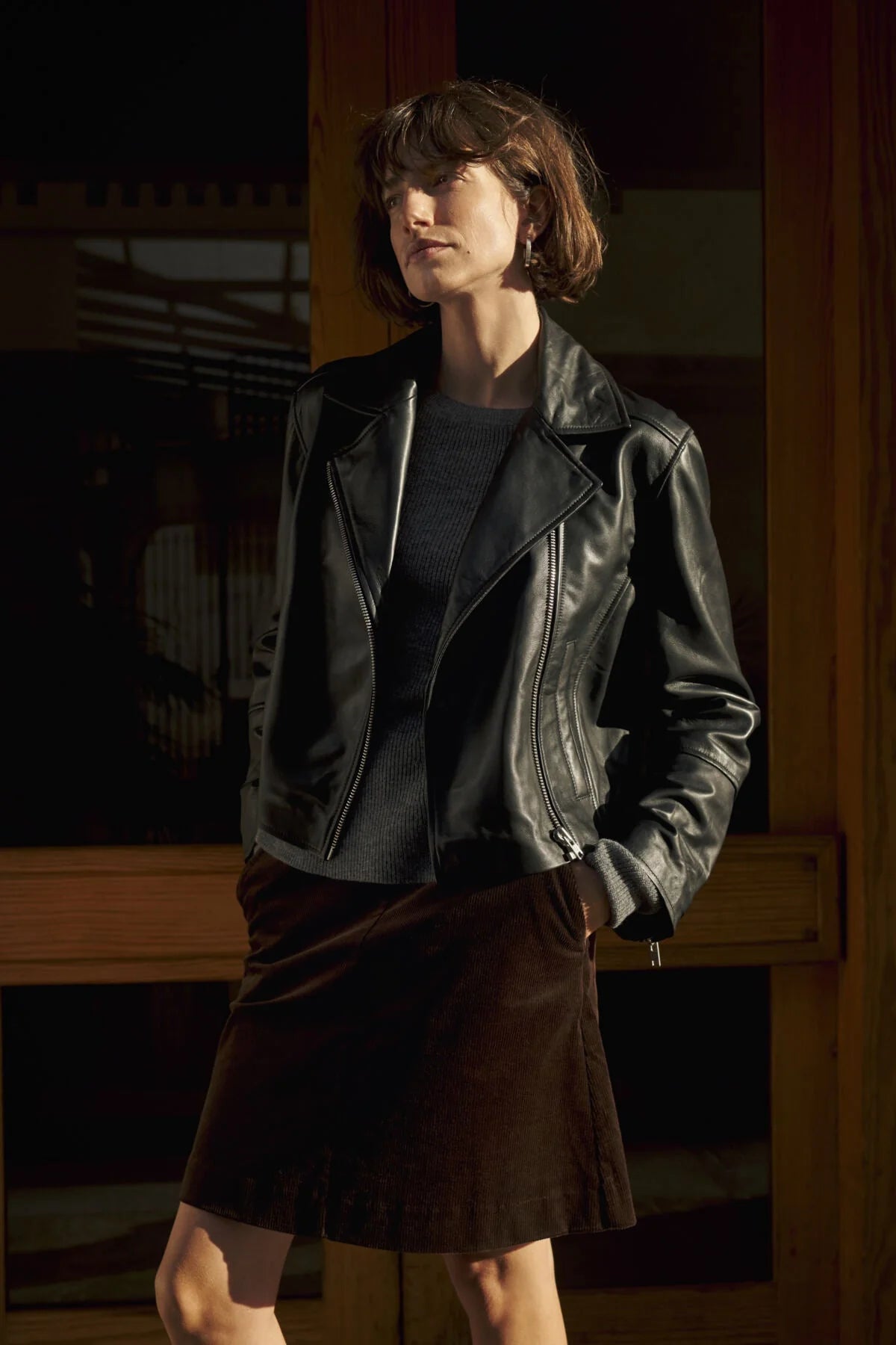 Dark brown corduroy midi skirt worn with black leather jacket