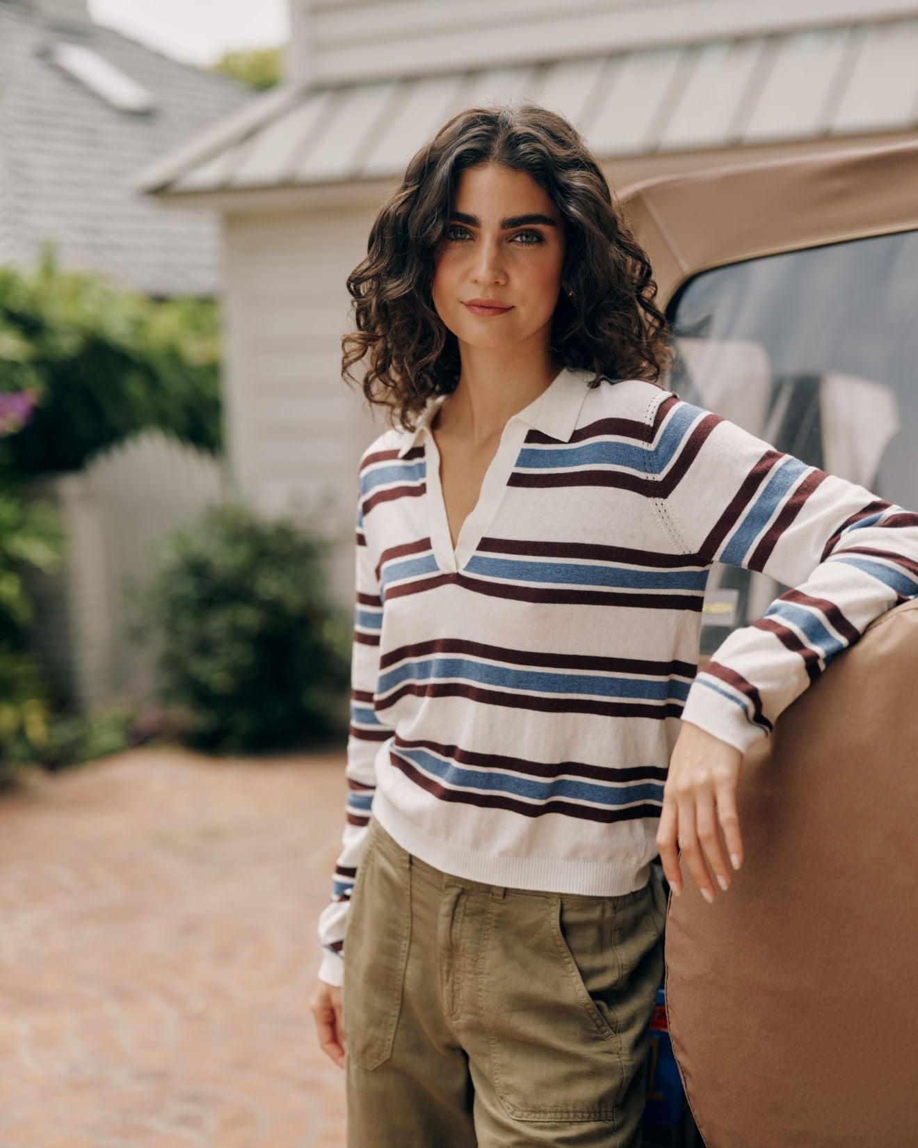 Model wearing Bella Dahl long sleeve striped placket pullover in garnet stripe with olive pants
