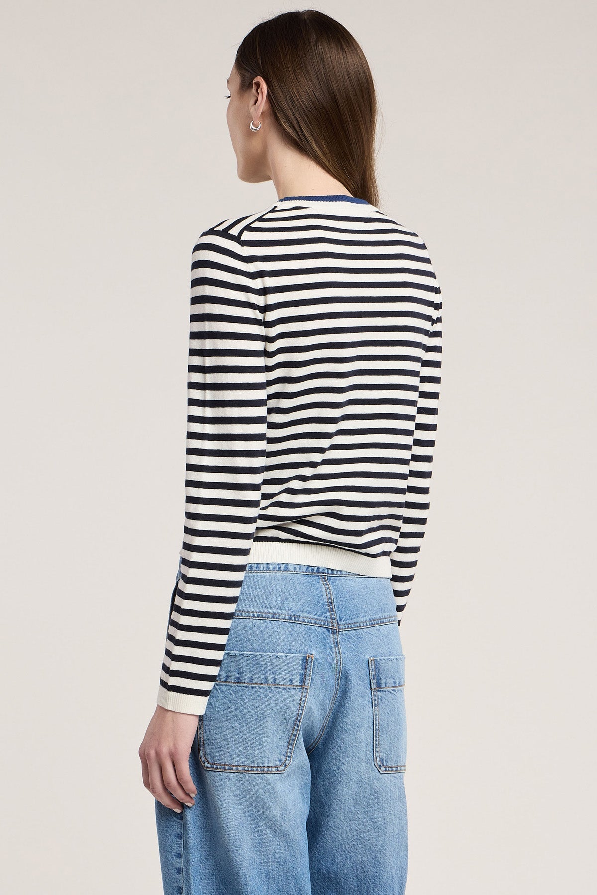 Back view of Velvet ROXY06 navy striped long-sleeve sweater paired with light blue jeans.