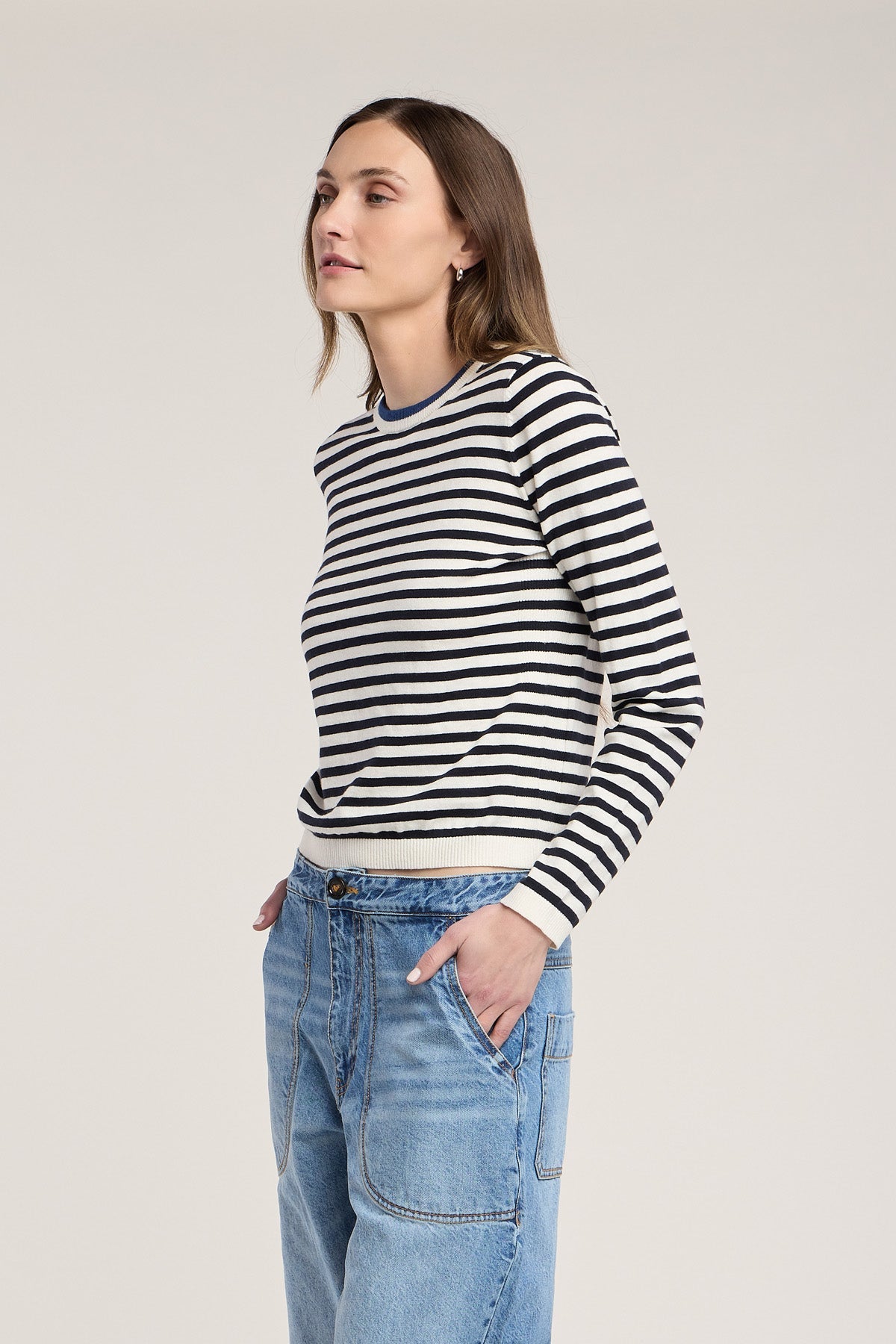 Model wearing Velvet ROXY06 navy and ivory striped crewneck sweater with light wash jeans