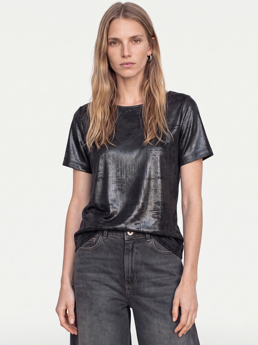 Model wearing Mos Mosh Niva O-SS metallic black short-sleeve tee with grey jeans