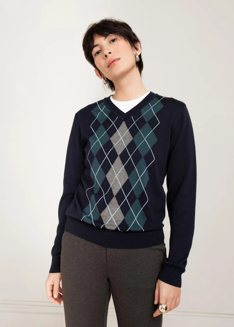 Model wearing Paper Label Felicia Argyle V-Neck Combo sweater in midnight blue with teal and grey diamond pattern