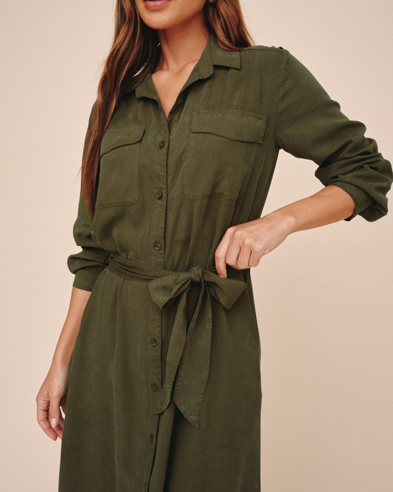 Close-up detail of olive green maxi shirt dress with patch pockets and tie waist belt