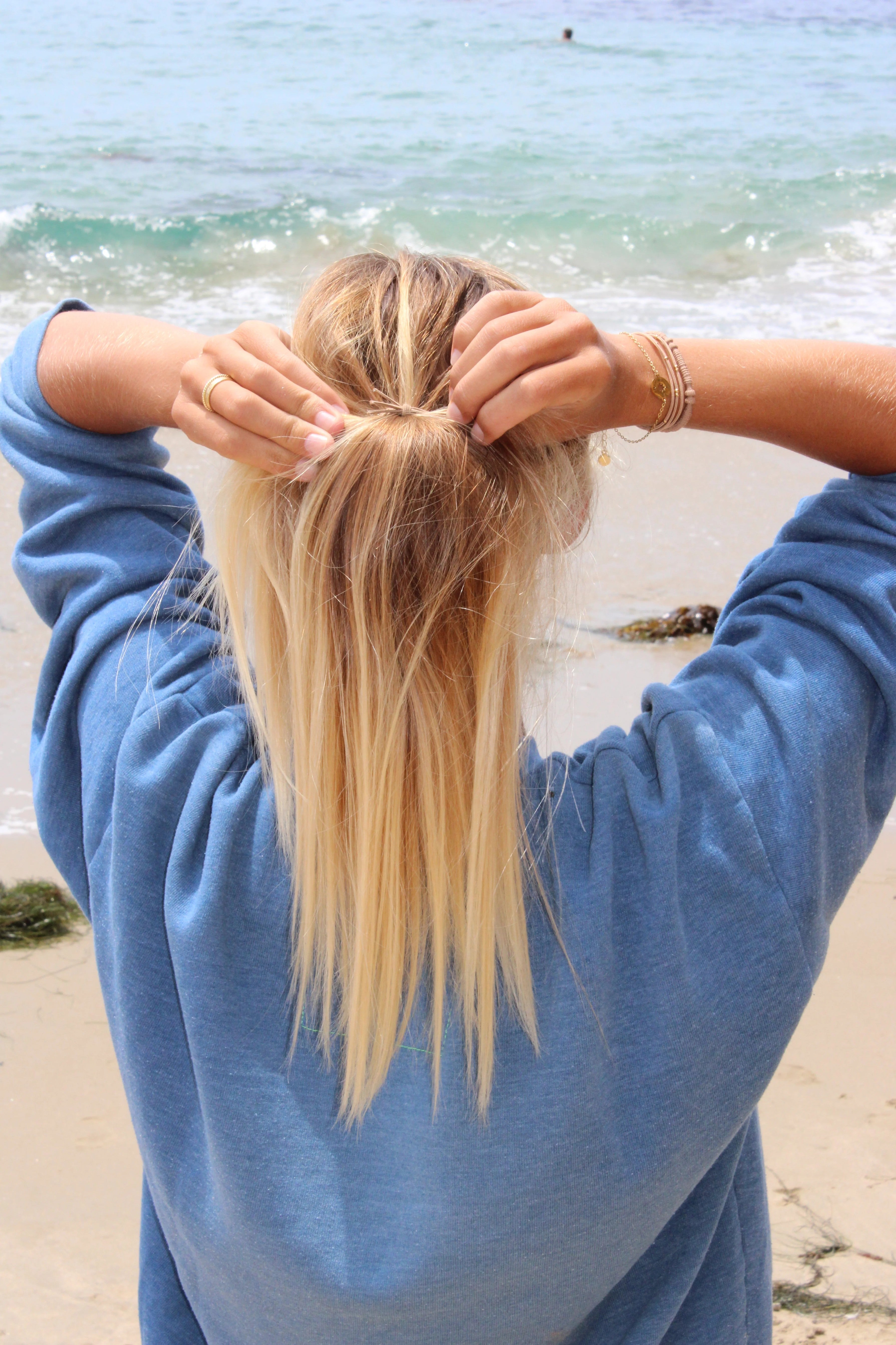 Model wearing Gypsea Bands La Jolla hair tie in blonde hair at beach