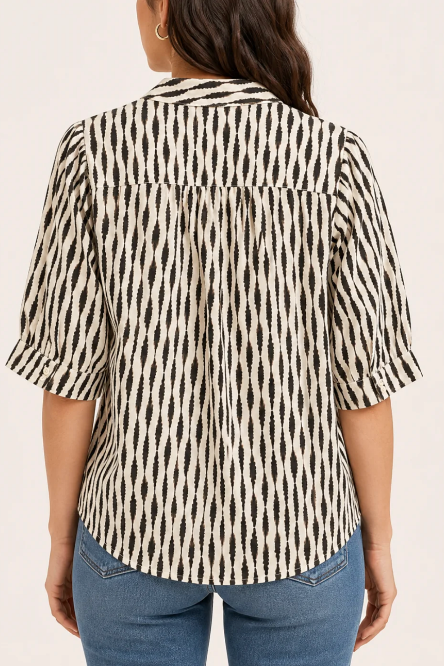 Back view of Sanctuary Eden Button Blouse in Ink Blot black and cream geometric print with rolled sleeves.