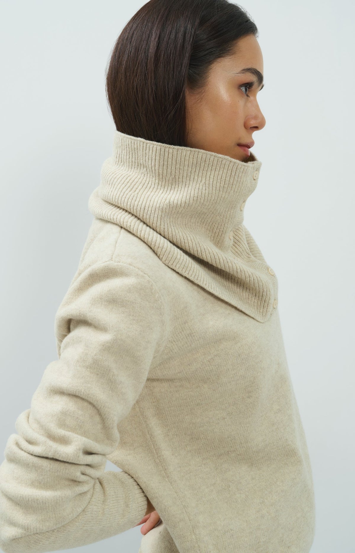 Model wearing YAYA light beige mix turtleneck sweater with scarf collar and buttons, side view