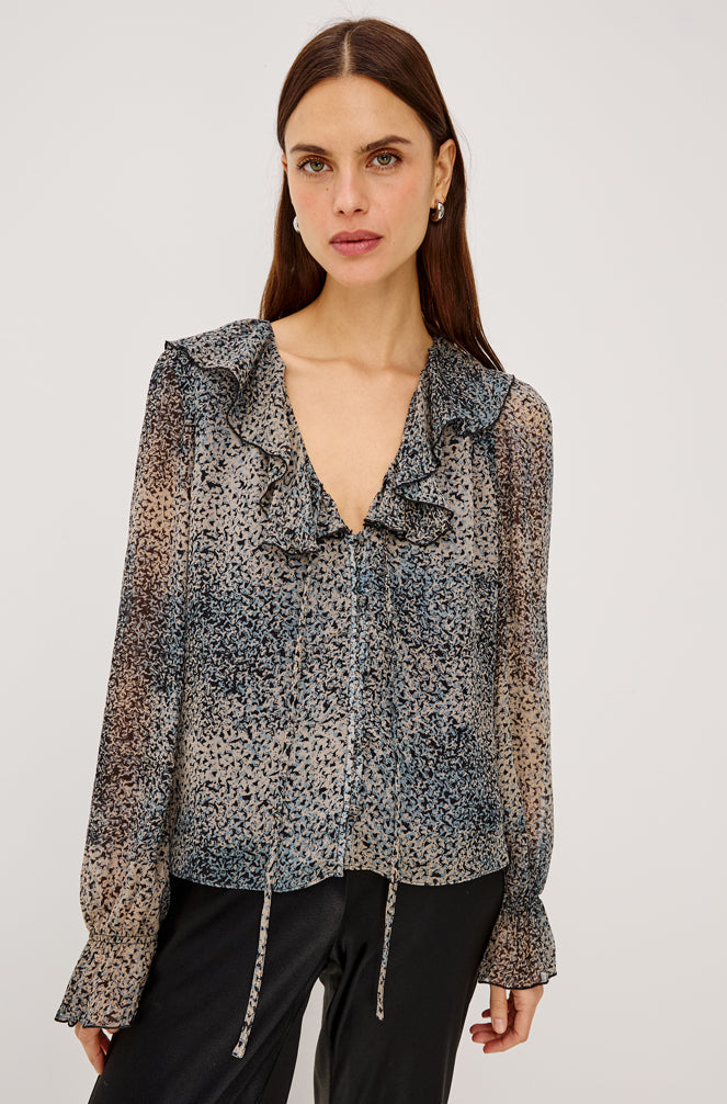 Model wearing Rails Becky blouse in Agate abstract print with ruffle V-neckline and long sleeves
